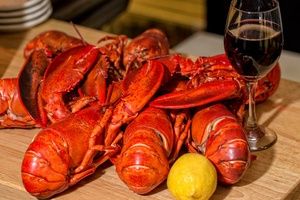 Cooked whole lobsters with a glass of wine